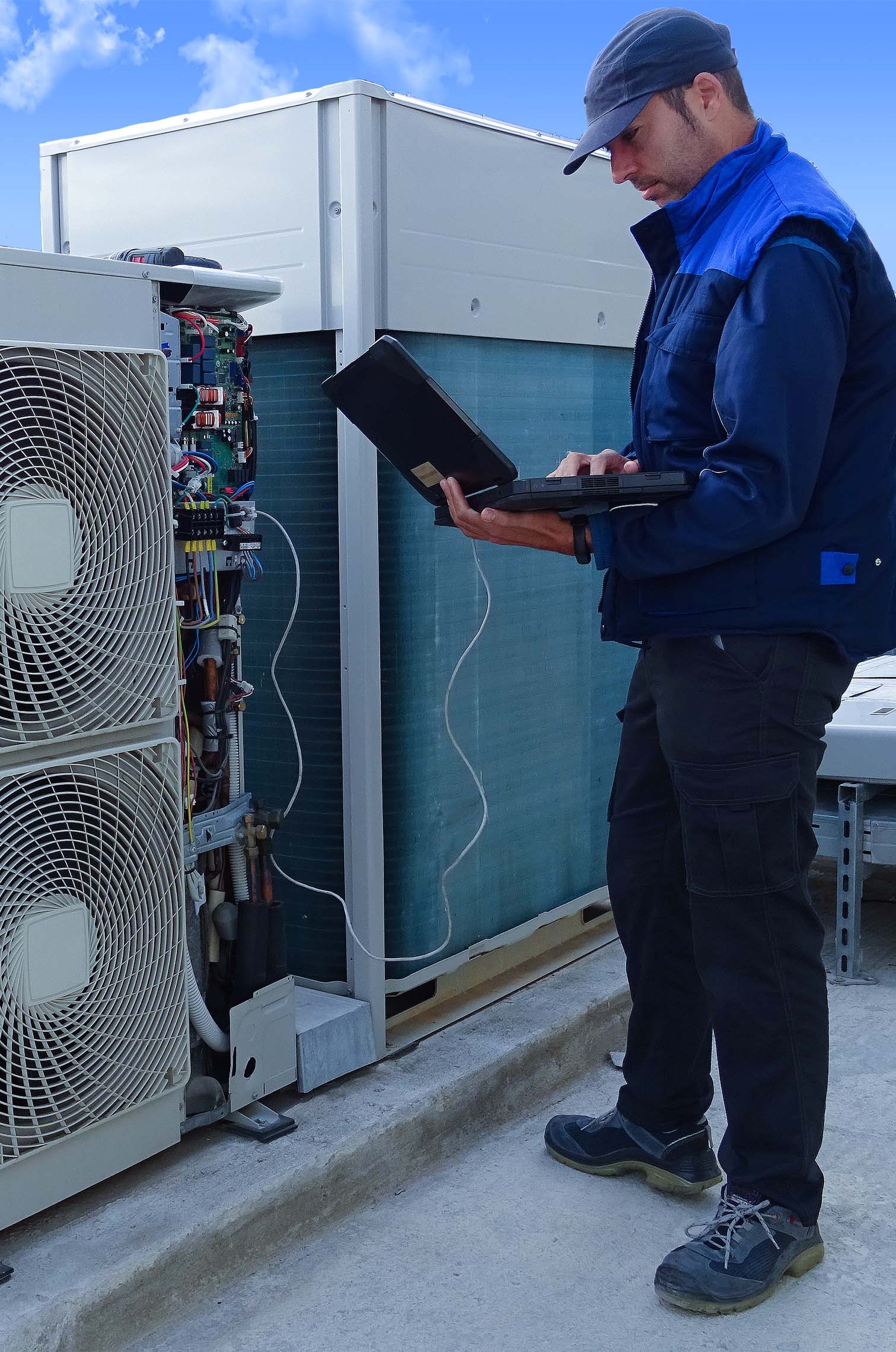 CLG Staff member checking a commercial air conditioning unit